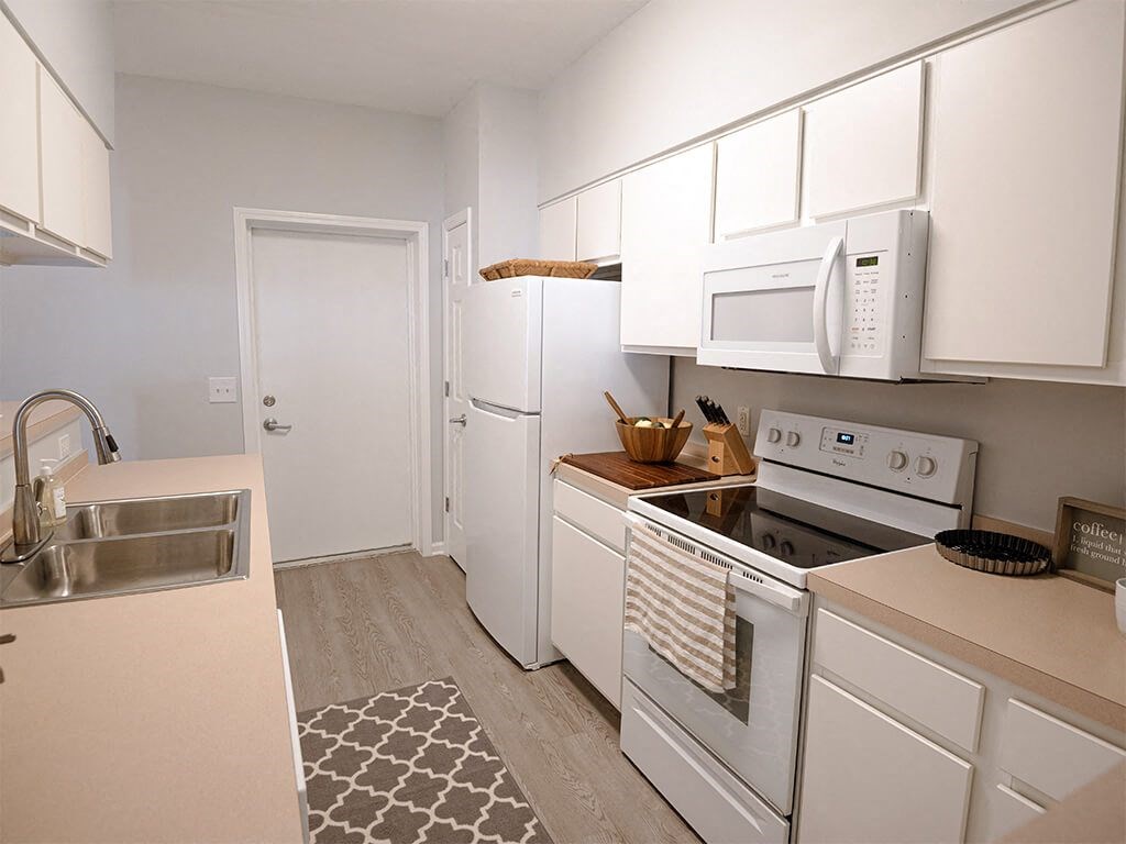 a kitchen with white appliances and white cabinets