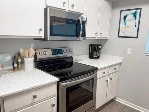 a kitchen with a stove and a microwave