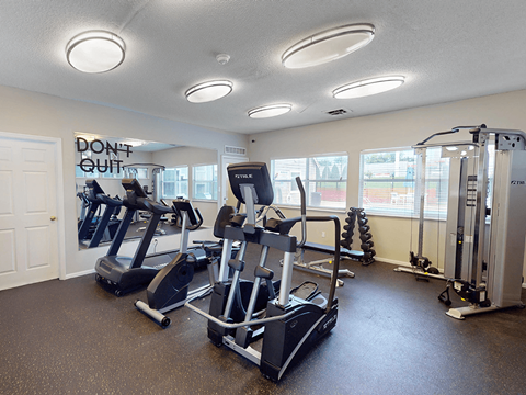 A gym with a sign that says, "Don't Quit."