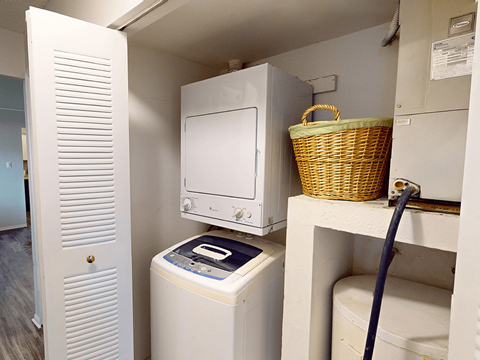 A white washing machine and dryer in a small laundry room.