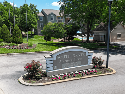 A sign for Southpointe Apartment Homes is in front of a building.