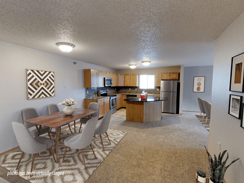 A kitchen with a table and chairs in the middle of the room.