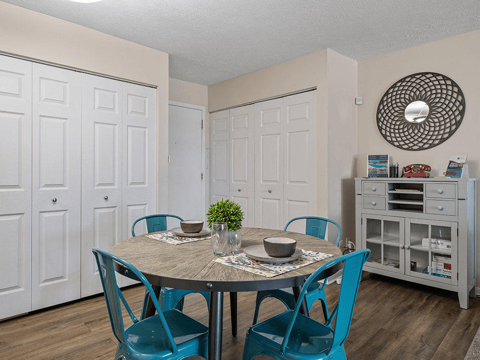 a dining room with a table and chairs