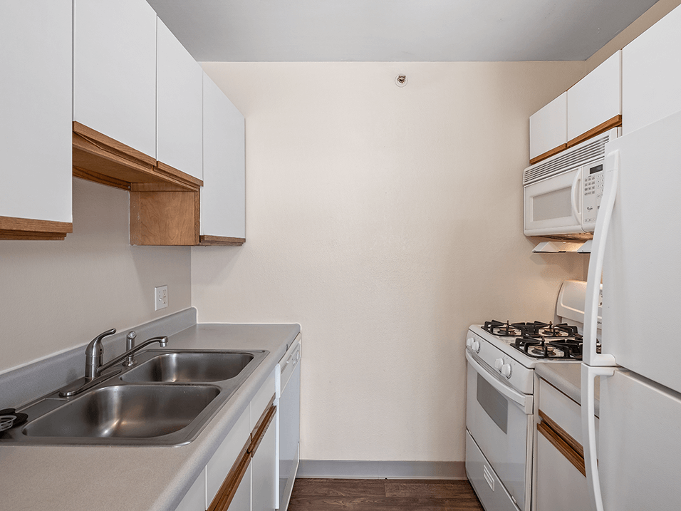 a kitchen with white appliances and white cabinets
