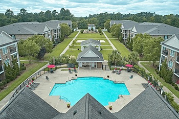 A large swimming pool in the middle of a housing complex.