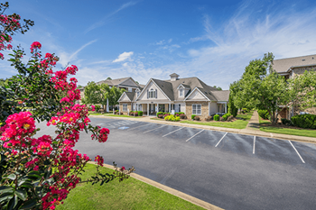 A large house with a driveway in front of it.