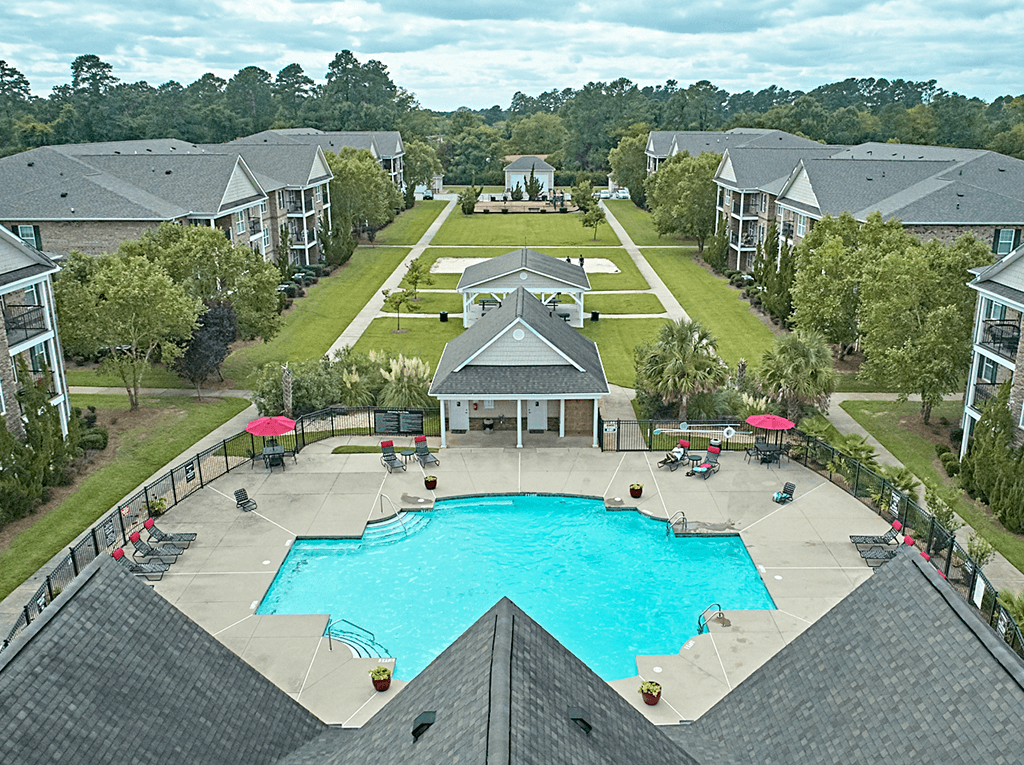 A large swimming pool surrounded by apartment buildings.