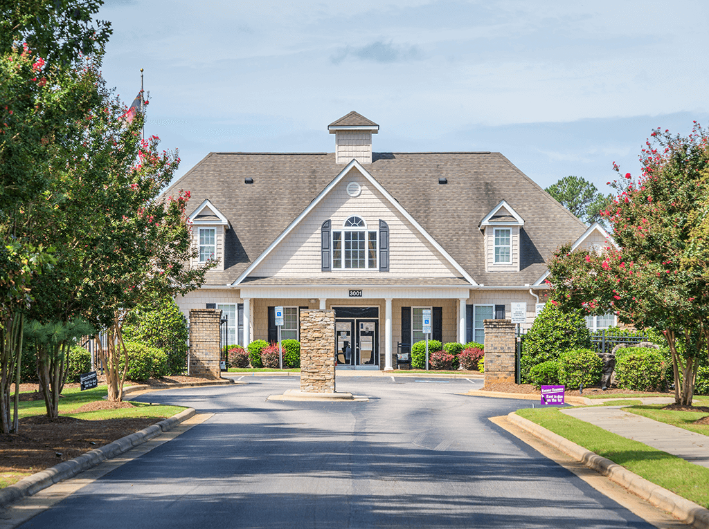 A large house with a driveway in front of it.