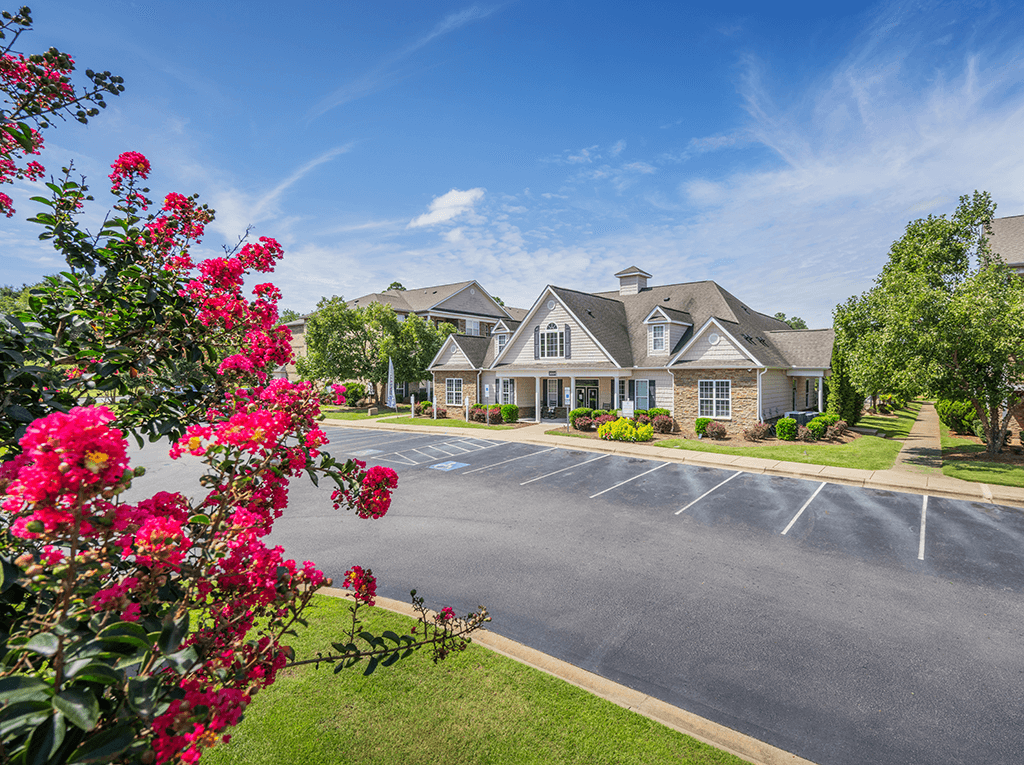 A building with a parking lot in front of it.