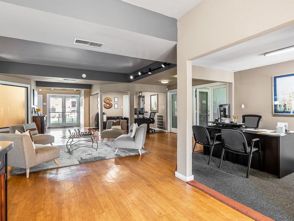A modern living room with a wooden floor and furniture.