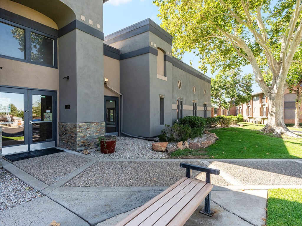 A modern building with a bench in front of it.