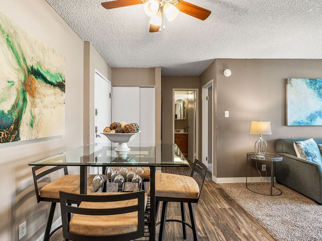 A dining room with a glass table and chairs.