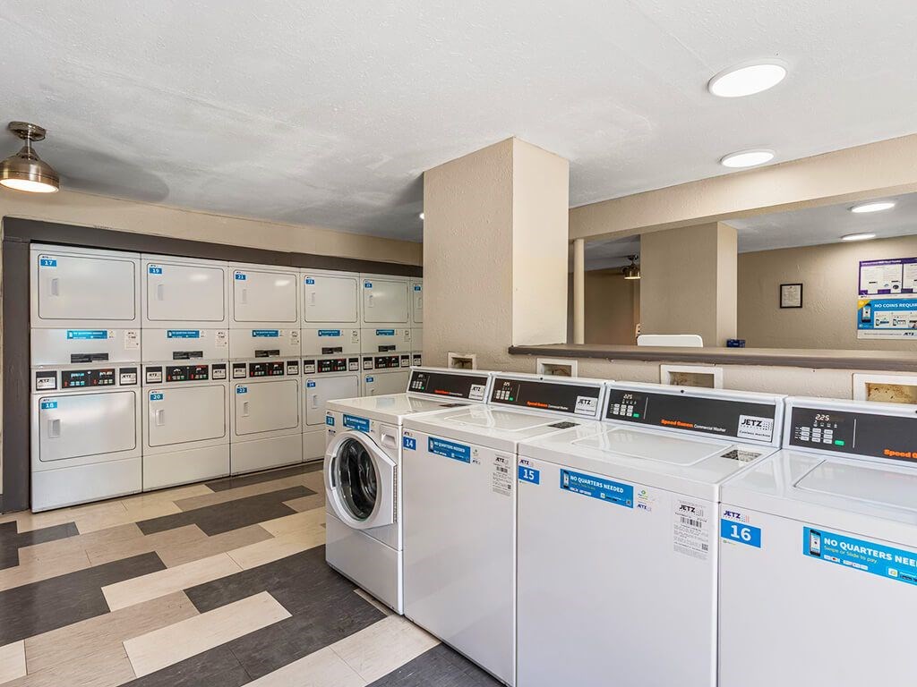 A row of washing machines in a laundromat.