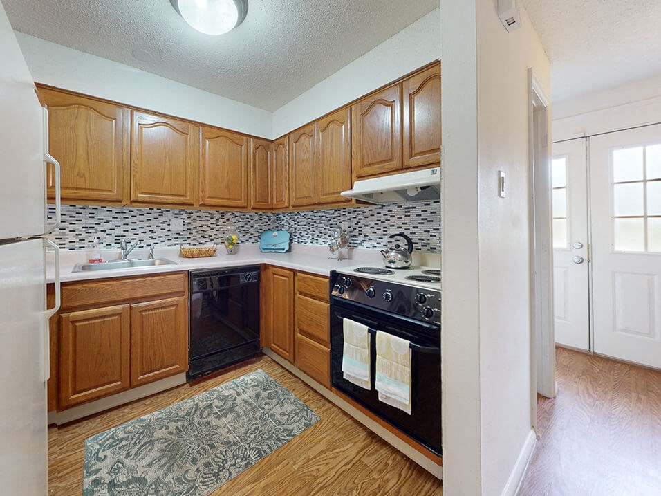 a kitchen with black appliances and wooden cabinets