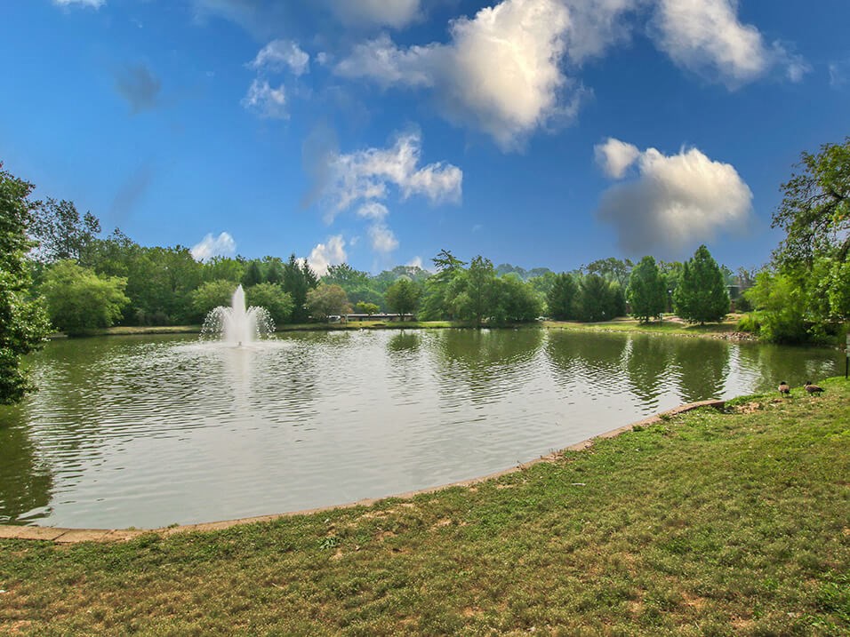 a fountain in the middle of a lake at apartment community