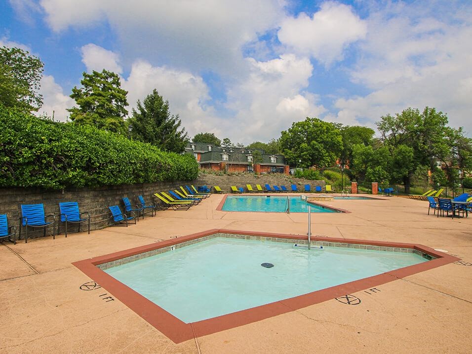 a swimming pool with chairs around it