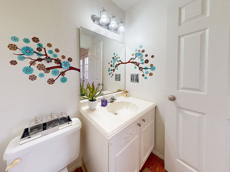 a white bathroom with a sink and a mirror