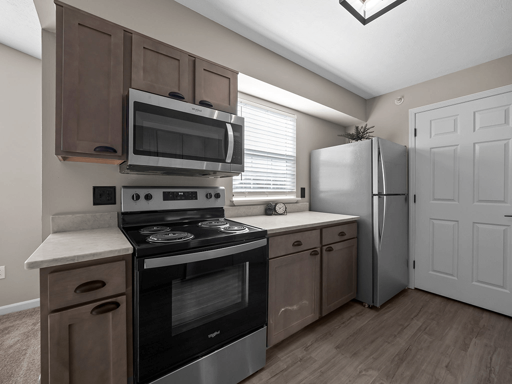 a kitchen with stainless steel appliances and a window