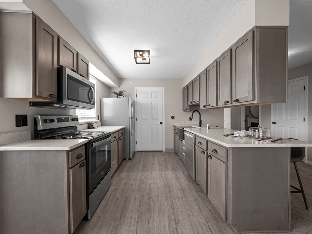 a kitchen with stainless steel appliances and white counter tops