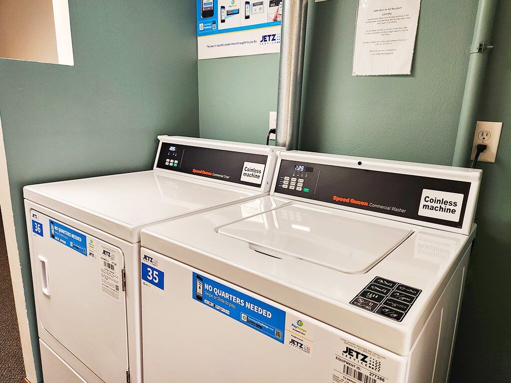 Two coinless machines are in a room with green walls.