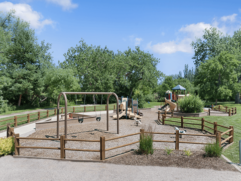 A playground with a swing set and a slide.