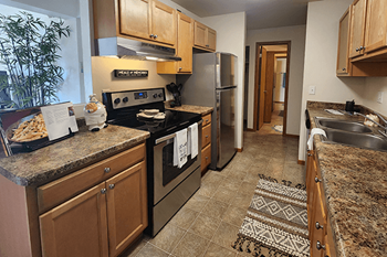 A kitchen with granite countertops and stainless steel appliances.