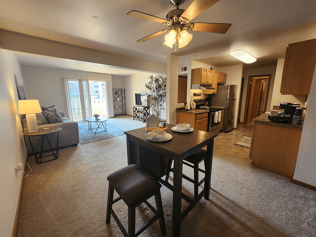 A living room with a dining table and chairs.
