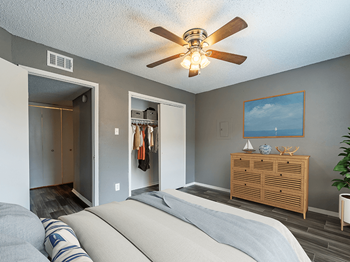 large bedroom with wood-style flooring and large closet - Photo Gallery 7