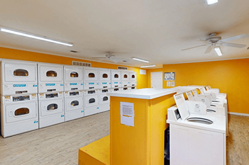 A row of ovens are lined up in a room.