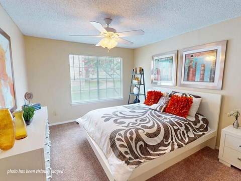 Bedroom with a bed, a ceiling fan, and a window.