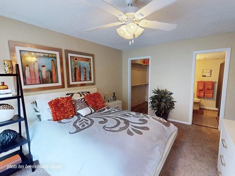 Bedroom with a bed, pillows, and a ceiling fan.