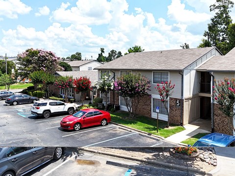 A red car is parked in a parking lot in front of a building with the number 5 on it.