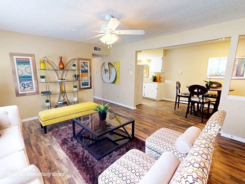 A living room with a yellow bench and a black coffee table.