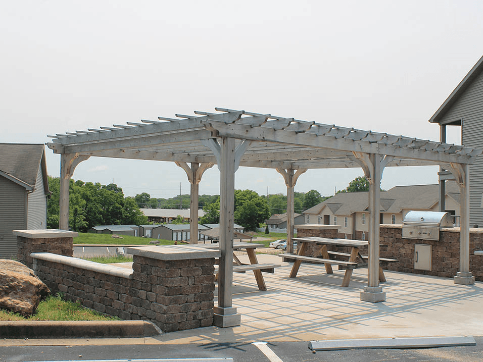 a pergola and picnic table on a patio