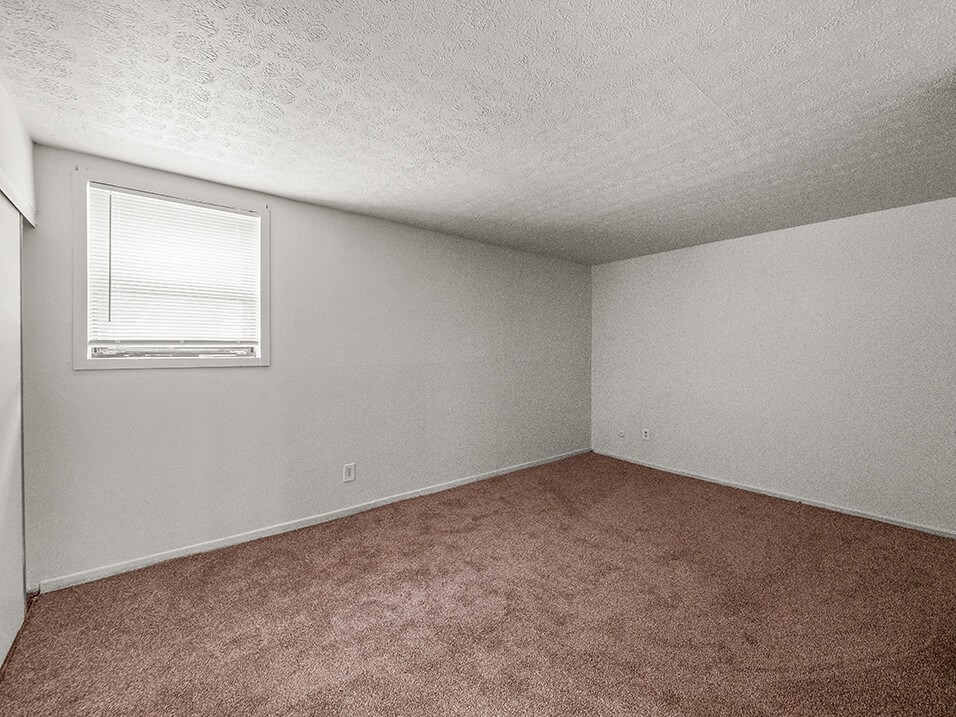 apartment bedroom with mini-blinds