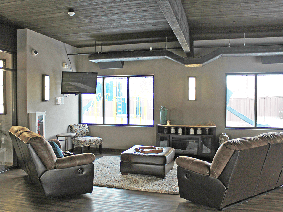 a living room with a tv and couches