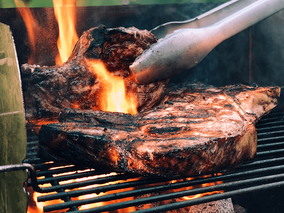 a steak being grilled on a grill