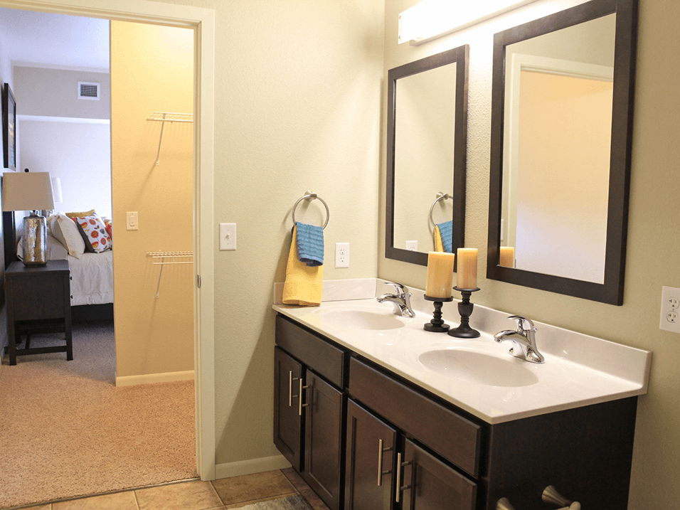 a bathroom with two sinks and two mirrors