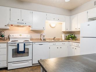 a kitchen with white cabinets and white appliances - Photo Gallery