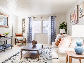 a living room with a white couch and blue and white curtains - Photo Gallery