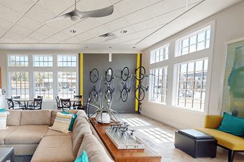 A living room with a tan couch and a yellow chair.