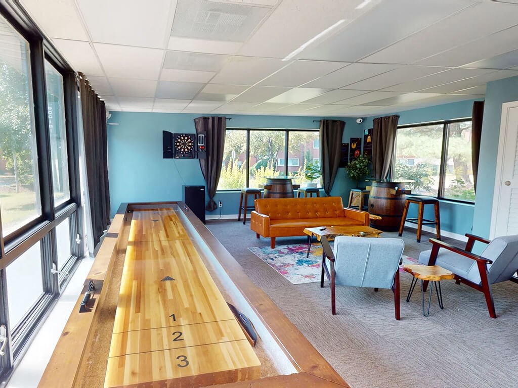 a bowling alley in a living room with furniture and windows