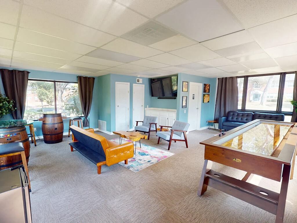 a living room filled with furniture and a pool table