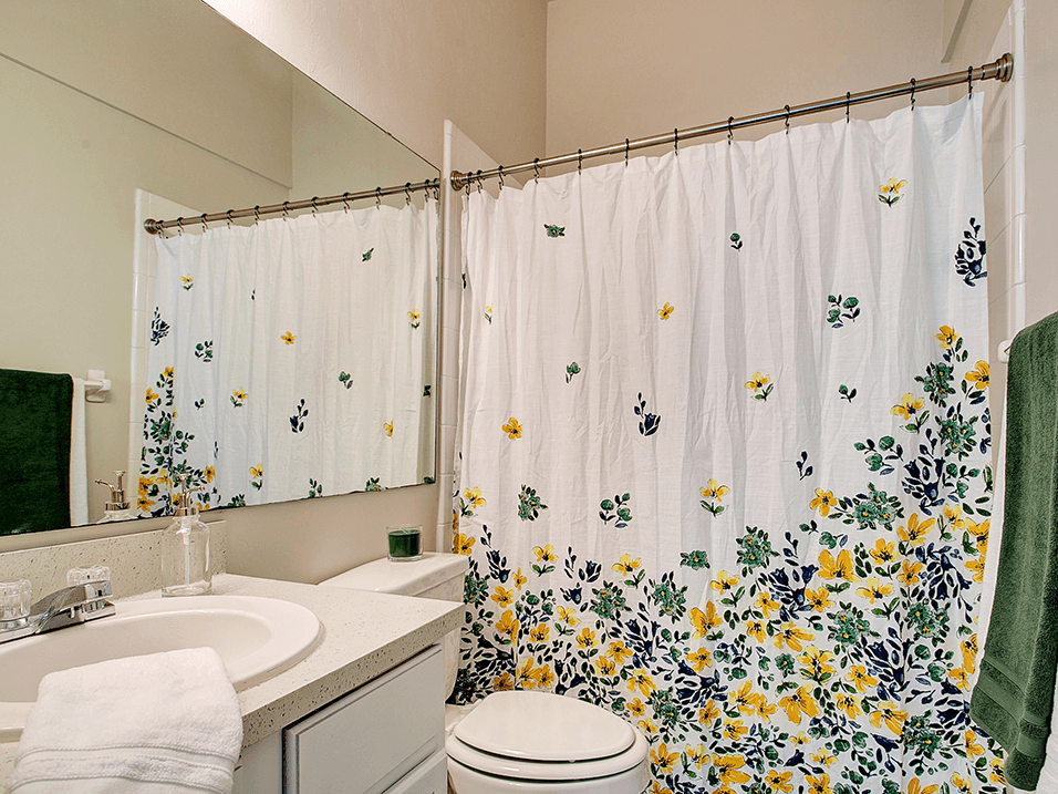 Bathroom with large mirror and tub