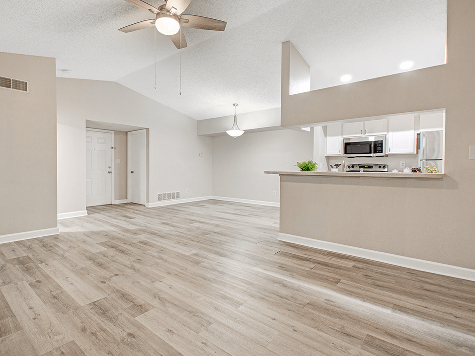 Living and dining area with wood flooring and granite counters