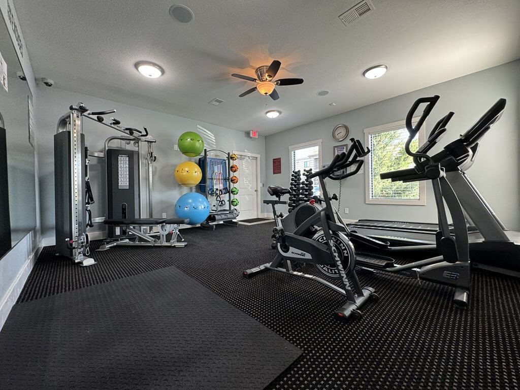 gym with a variety of equipment  at apartment community