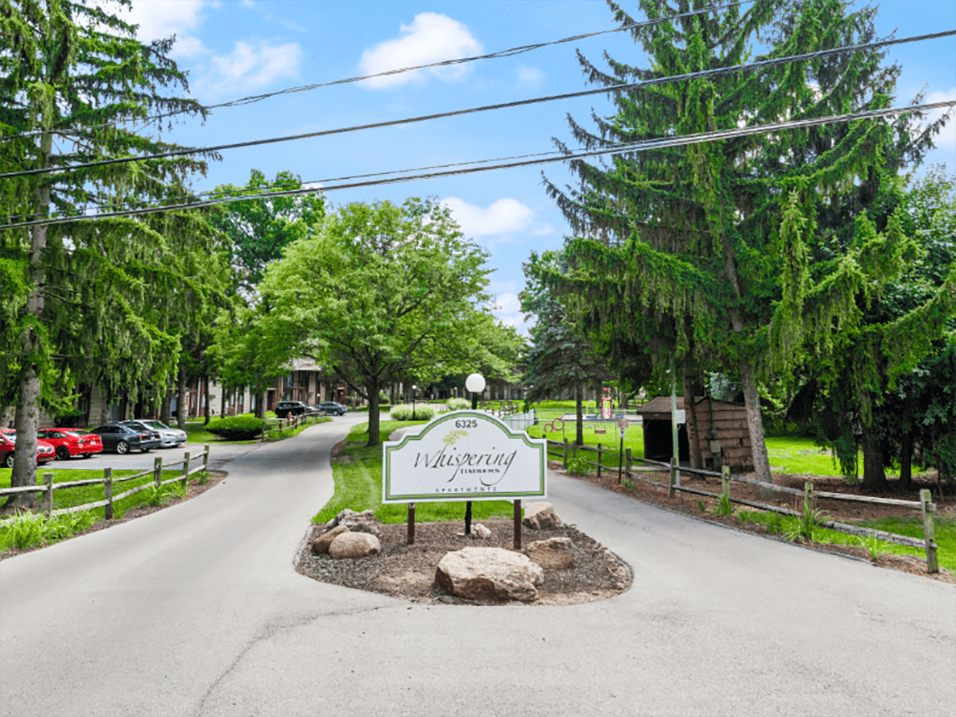 welcome sign at Whispering Timbers community