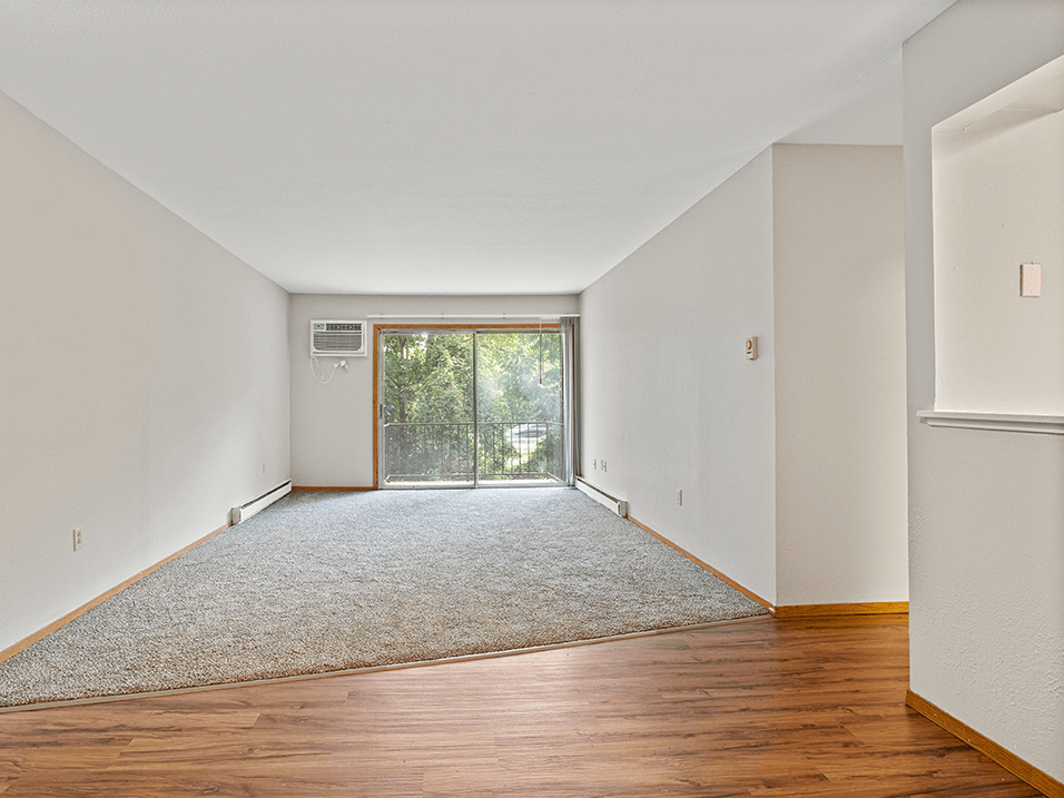 apartment living room with wood floors and a sliding glass door