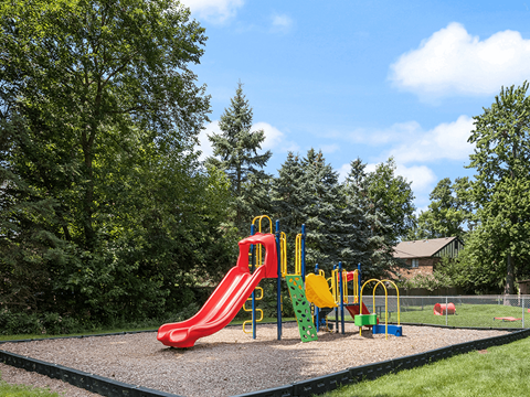a playground with a slide at an apartment community