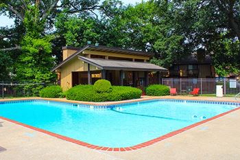 a swimming pool with a house in the background